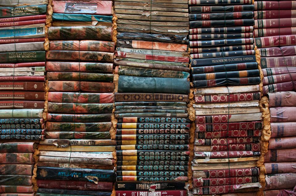 Rows of old bound books on a shelf